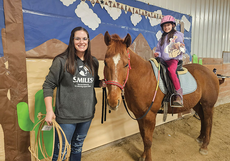 student riding horse