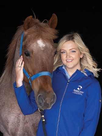 Woman standing with horse