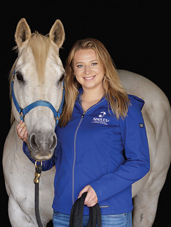 Woman standing with horse