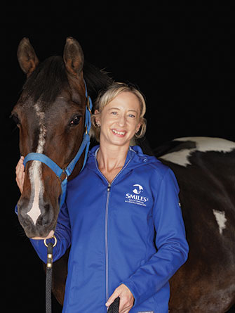 Woman standing with horse