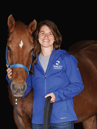 Woman standing with horse