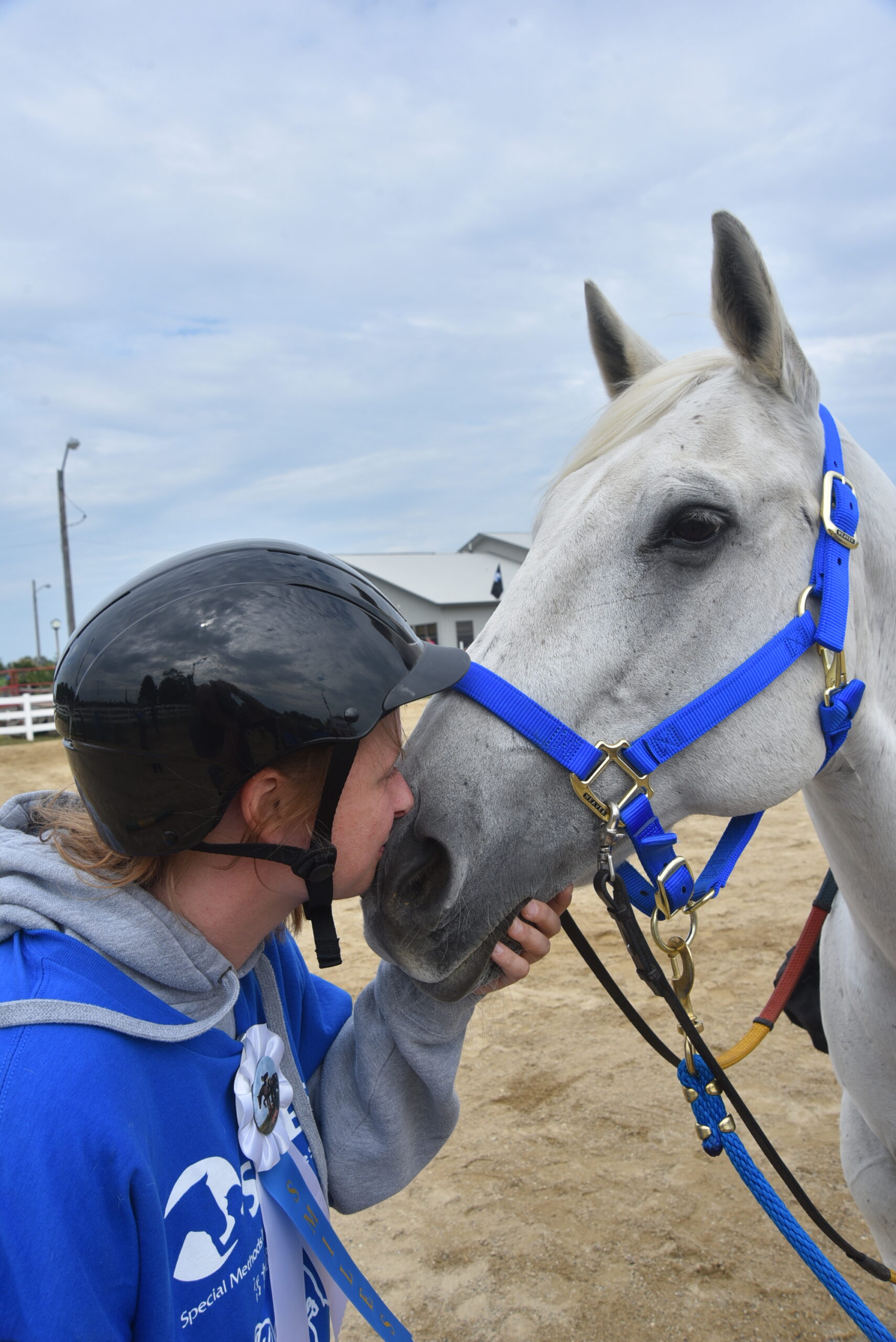 person hugging horse