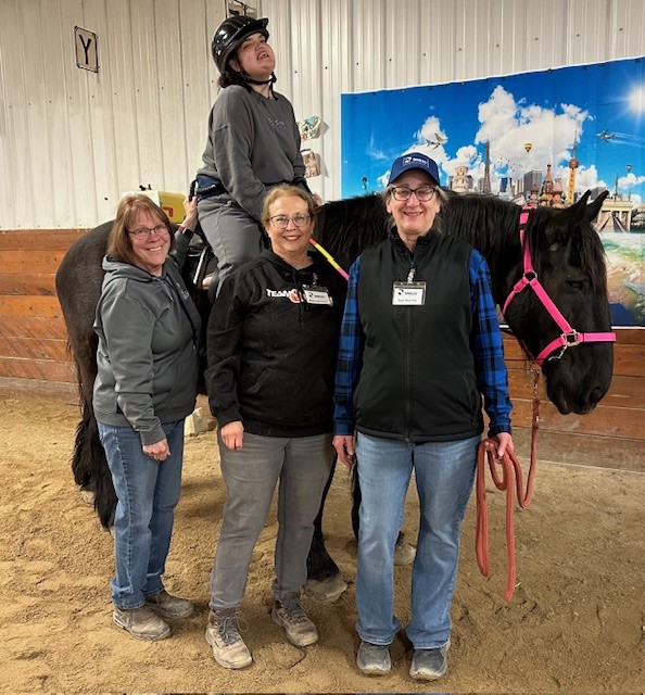 student riding horse