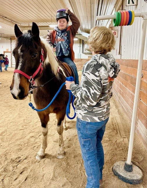 student riding on horse
