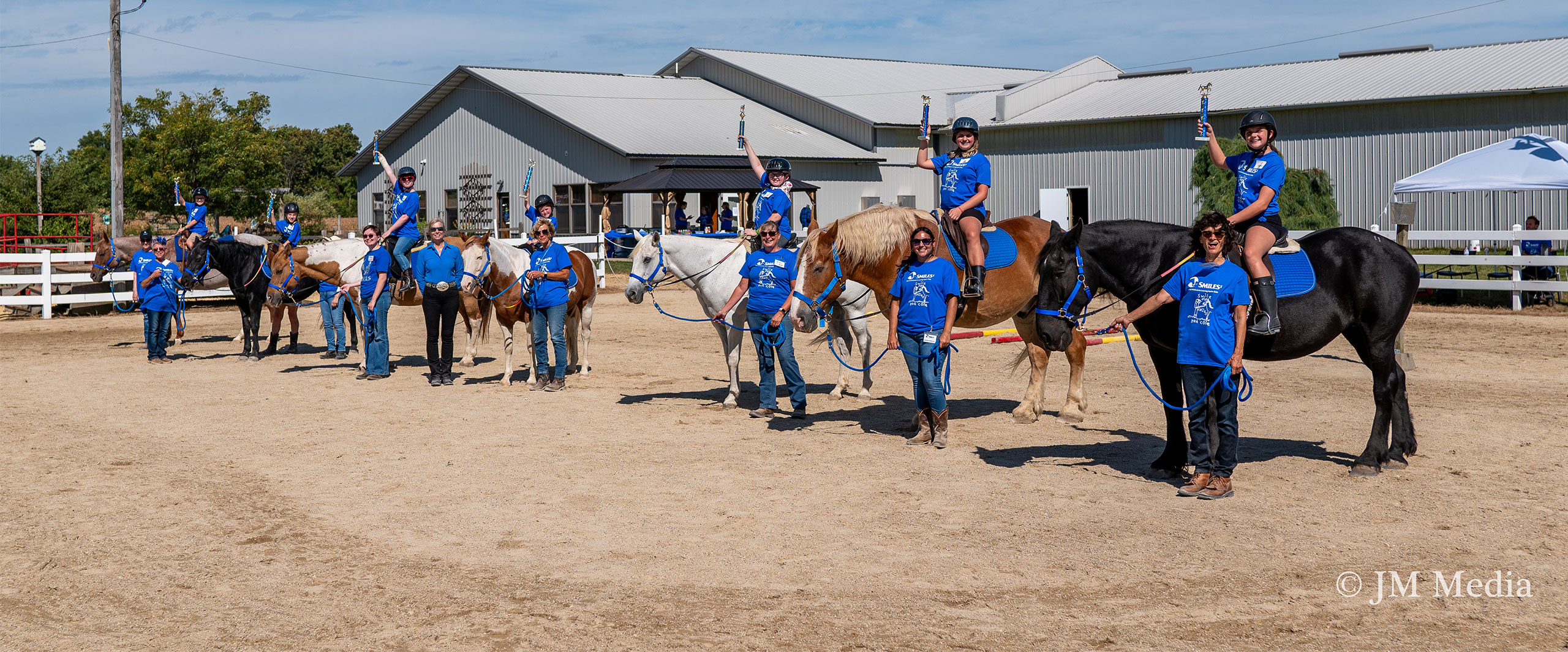 people on horses showing trophies
